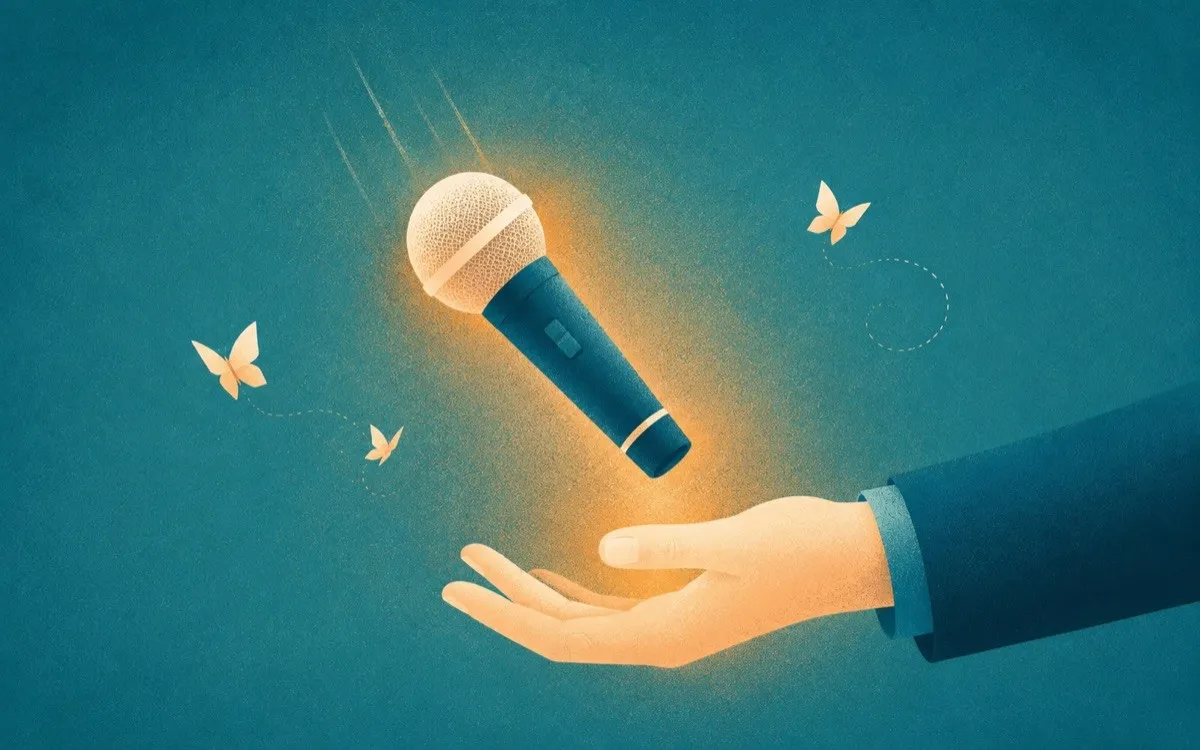 A hand catching a falling microphone as paper butterflies drift by, a metaphor for managing stage fright before a presentation