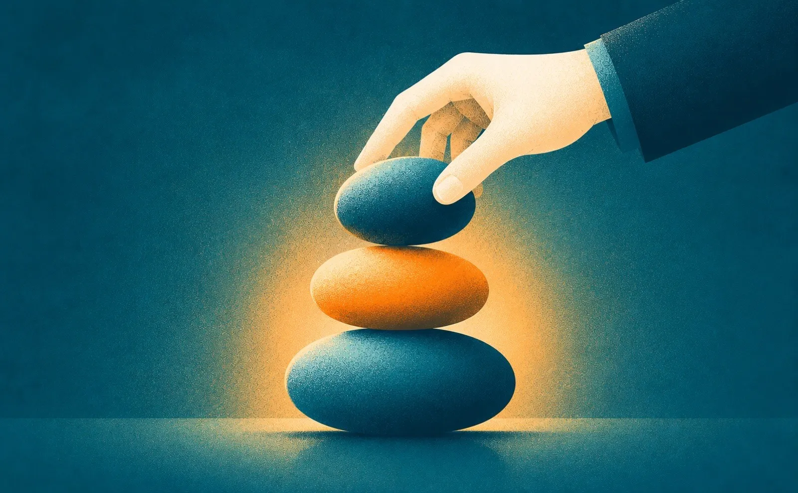 A hand balancing the top stone on a cairn of three, a metaphor for a three step approach to a persuasive presentation